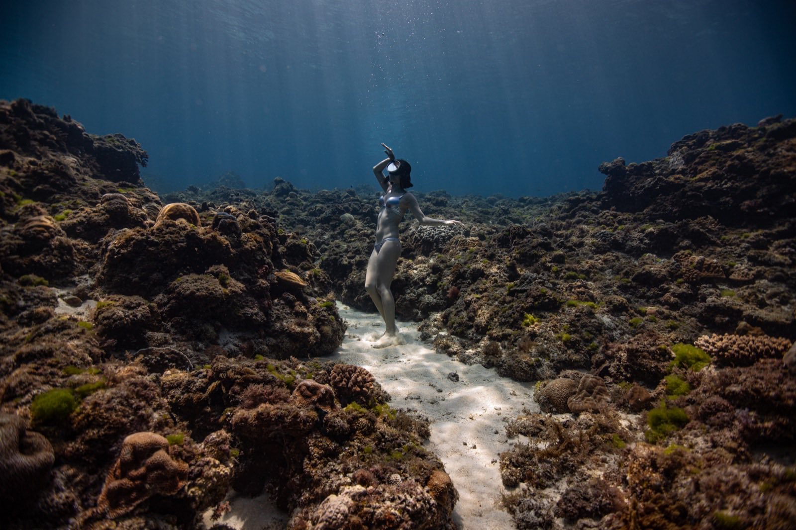 A freediver stretching out underwater