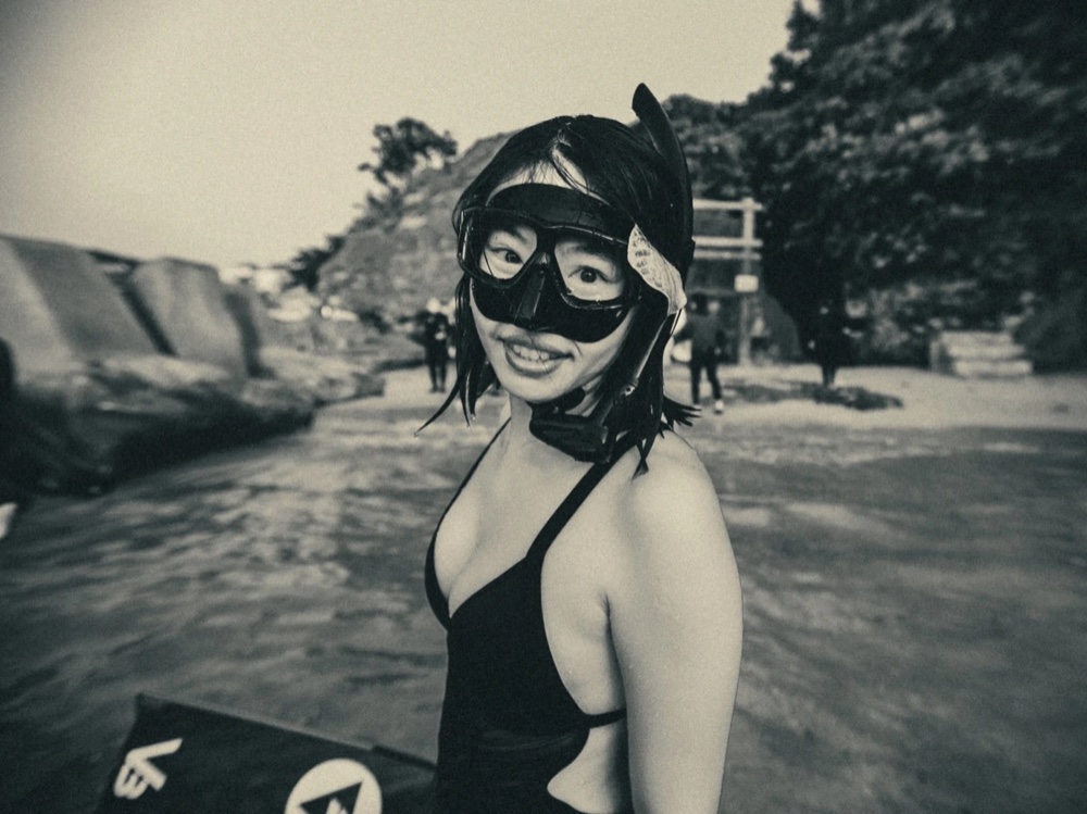 Instructor Eliz in mask and hood at the shore